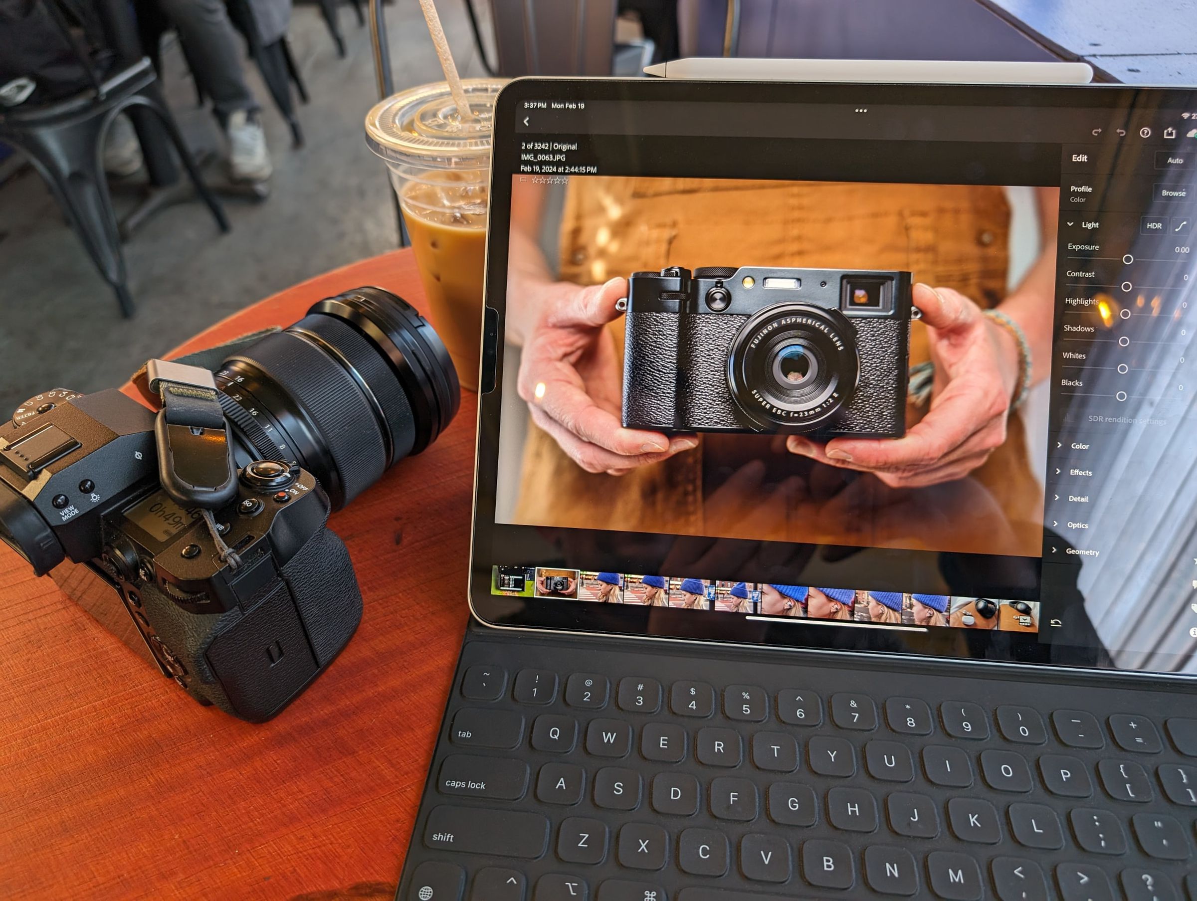A photo of an iPad Pro attached to Apple’s Smart Keyboard Folio, with a camera to the left.